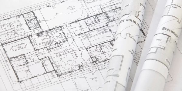 Rolled up blueprint of a house plan.